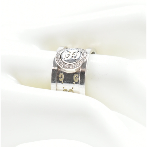 469 - A Gucci hallmarked 18ct white gold & diamond ring. The ring having a central circular swivel head se... 