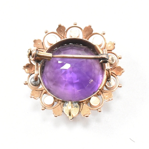 471 - An early 20th century amethyst and pearl brooch pin.  The brooch set with a central mixed cut amethy... 