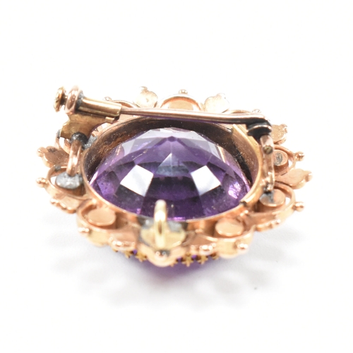 471 - An early 20th century amethyst and pearl brooch pin.  The brooch set with a central mixed cut amethy... 