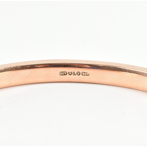 480 - A 9ct rose gold etched design bangle armlet. The bracelet / arm band of circular reverse D form havi... 