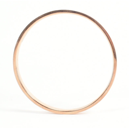 480 - A 9ct rose gold etched design bangle armlet. The bracelet / arm band of circular reverse D form havi... 