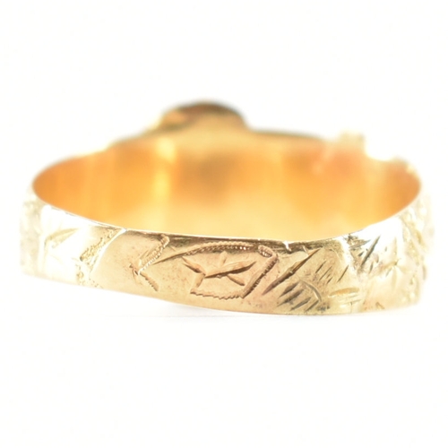 488 - A hallmarked 18ct yellow gold buckle ring. The ring in the form of a fastened belt having etched fol... 