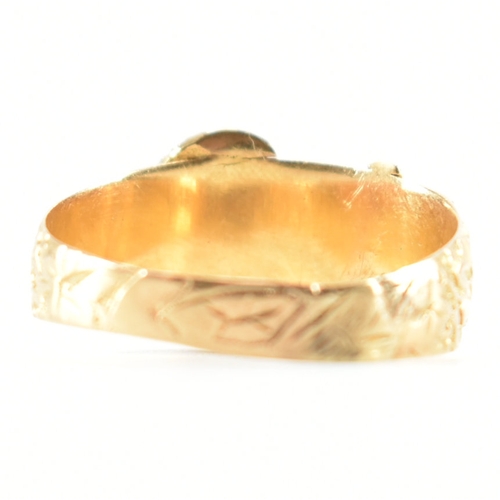 488 - A hallmarked 18ct yellow gold buckle ring. The ring in the form of a fastened belt having etched fol... 