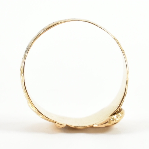 488 - A hallmarked 18ct yellow gold buckle ring. The ring in the form of a fastened belt having etched fol... 