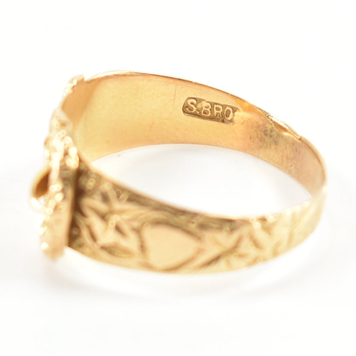 488 - A hallmarked 18ct yellow gold buckle ring. The ring in the form of a fastened belt having etched fol... 