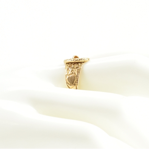 488 - A hallmarked 18ct yellow gold buckle ring. The ring in the form of a fastened belt having etched fol... 