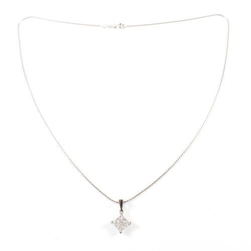 496 - A hallmarked 18ct white gold and diamond pendant necklace.  The necklace strung with a square pendan... 