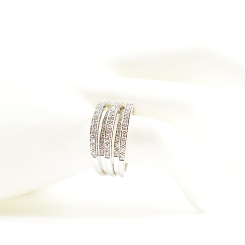 497 - A hallmarked 9ct white gold and diamond five band ring. The ring being set with round cut diamond ac... 