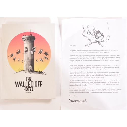 70 - Banksy (British, b 1973)
 The Walled Off Hotel Box - Ikea edition - COA hotel receipt - Postcards
 F... 