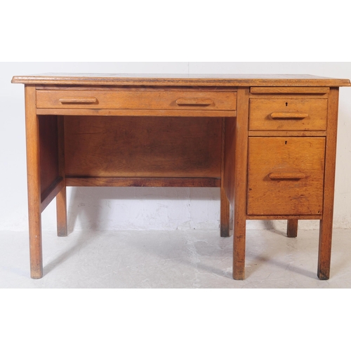 552 - A vintage mid 20th century oak ministry of defence office desk table. Of rectangular form with knee ... 