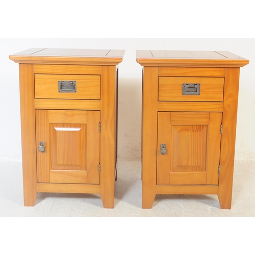 557 - A pair of contemporary oak bedside cabinet / tables. Of rectangular form with a flared top with sing... 