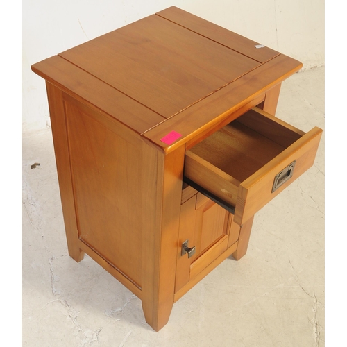 557 - A pair of contemporary oak bedside cabinet / tables. Of rectangular form with a flared top with sing... 