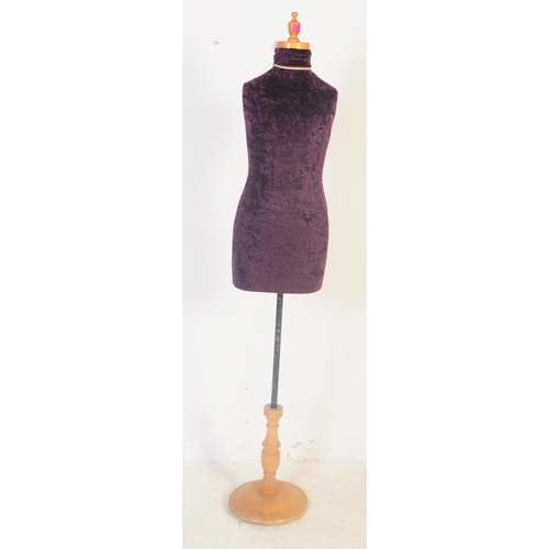 561 - A vintage 20th century haberdashery tailors female mannequin having a purple crushed velvet body ove... 