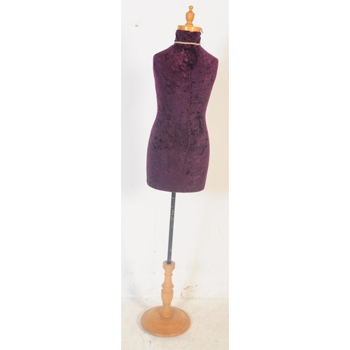 561 - A vintage 20th century haberdashery tailors female mannequin having a purple crushed velvet body ove... 