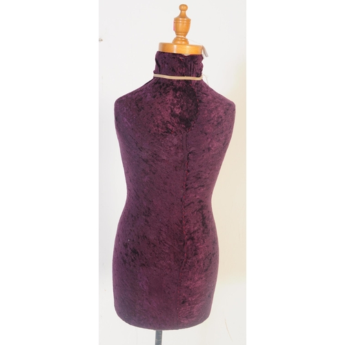 561 - A vintage 20th century haberdashery tailors female mannequin having a purple crushed velvet body ove... 