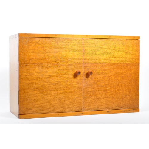 562 - A mid 20th century vintage teak and plywood medicine wall cabinet fitting. Comprising of twin hinged... 