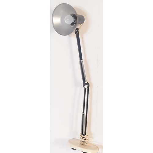 567 - A retro 20th century black metal anglepoise articulated desk table lamp light. The light having a co... 