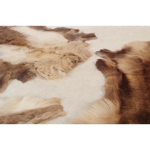 568 - A collection of five vintage retro mid 20th century reindeer skins / pelts / floor rugs. Largest mea... 