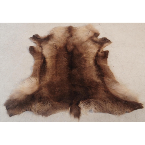 568 - A collection of five vintage retro mid 20th century reindeer skins / pelts / floor rugs. Largest mea... 