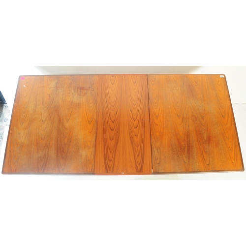 579 - A retro mid 20th century teak dining table. The table of rectangular form having rounded chamfered e... 