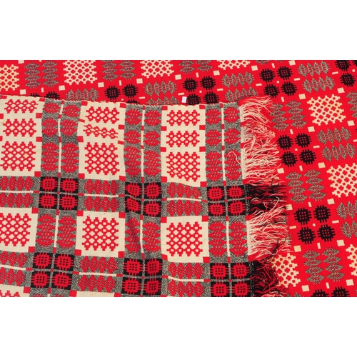 583 - A vintage 20th century Welsh blanket. Of rectangular form with geometric pattern squares, in red, wh... 