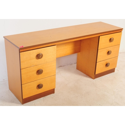 585 - A vintage 1980's faux teak wood dressing table and matching bedside cabinets. The dressing table hav... 