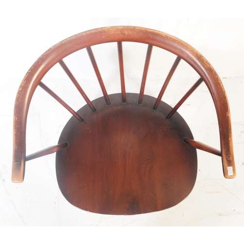 587 - Ercol - A retro 20th century Ercol dark beech & Elm nursing chair being raised on turned legs with e... 