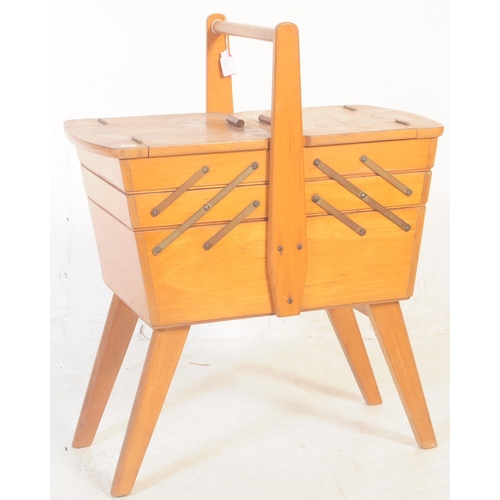 598 - A retro mid 20th century beech cantilever sewing box. Of rectangular form with carry handle to top w... 