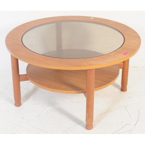 608 - British Modern Design - A retro 20th century circular glazed coffee table. The table having smoked g... 