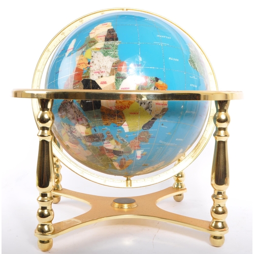 612 - A Lapis Lazuli encrusted table top / desk top revolving world globe. The gilt metal frame housing a ... 