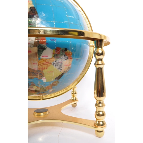 612 - A Lapis Lazuli encrusted table top / desk top revolving world globe. The gilt metal frame housing a ... 