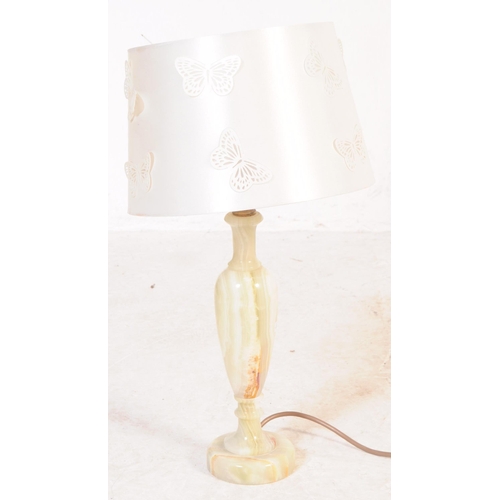 619 - A group of four mid 20th century turned onyx table lamp lights. With light fixings to top, into a ta... 