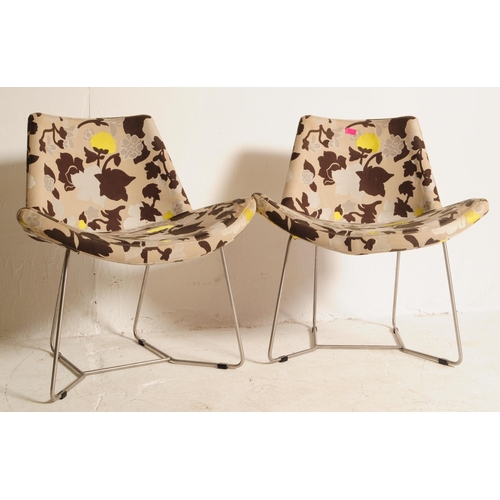 631 - A pair of 20th century upholstered tub armchairs. The chair being upholstered in a contemporary flor... 