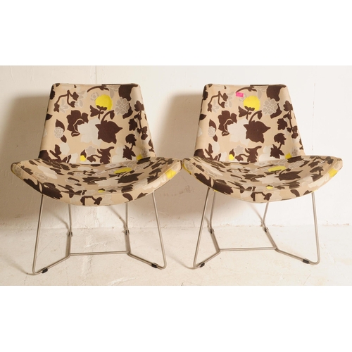 631 - A pair of 20th century upholstered tub armchairs. The chair being upholstered in a contemporary flor... 