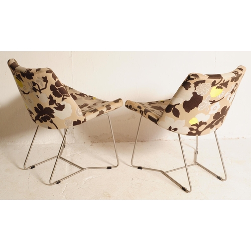 631 - A pair of 20th century upholstered tub armchairs. The chair being upholstered in a contemporary flor... 