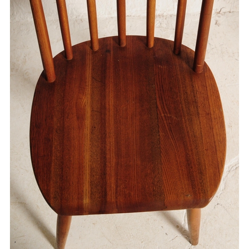 634 - A set of three retro mid 20th century teak spindle back dining chairs. The chair shaving shaped top ... 