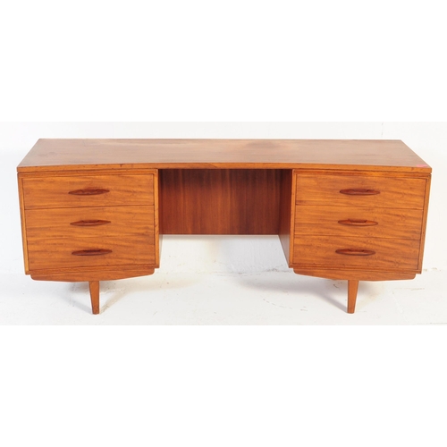 644 - Avalon - A retro mid 20th century teak desk having curvilinear top over kneehole flanked by twin ban... 