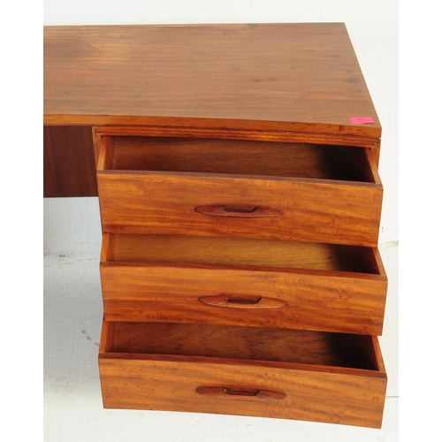 644 - Avalon - A retro mid 20th century teak desk having curvilinear top over kneehole flanked by twin ban... 