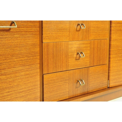 650 - Stonehill Furniture - A retro 20th century teak sideboard credenza. Of rectangular form with a bank ... 