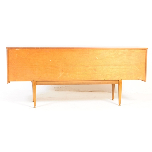 650 - Stonehill Furniture - A retro 20th century teak sideboard credenza. Of rectangular form with a bank ... 