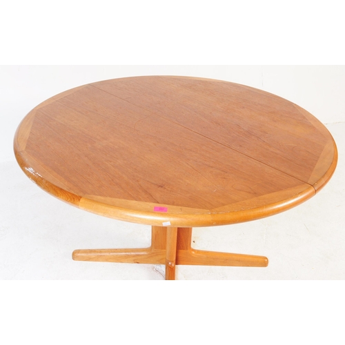 654 - Mid-century Danish manner teak wood circular dining table. Raised on splayed legs with extending act... 