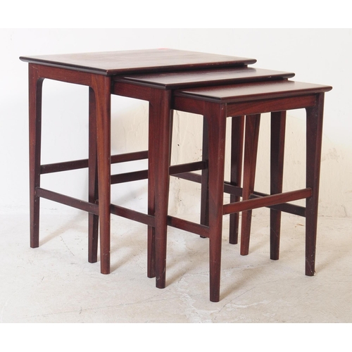 657 - A retro mid 20th century mahogany nest of tables. Of graduating size, rectangular form with upright ... 