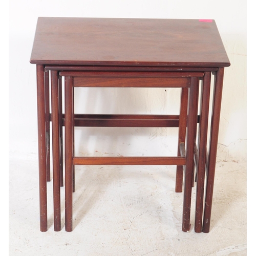 657 - A retro mid 20th century mahogany nest of tables. Of graduating size, rectangular form with upright ... 