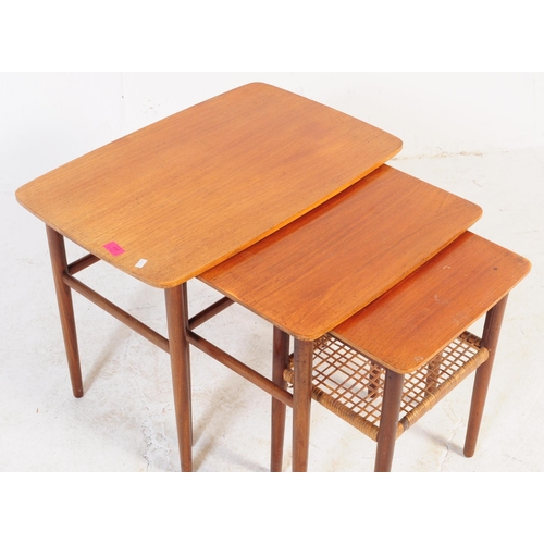 658 - A mid-century Danish manner dark teak wood nest of tables being raised on tapering legs with stretch... 