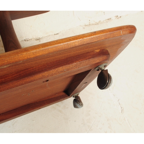 674 - A mid century large two tier teak wood coffee table. Raised on stub shaped legs with twin chamfered ... 