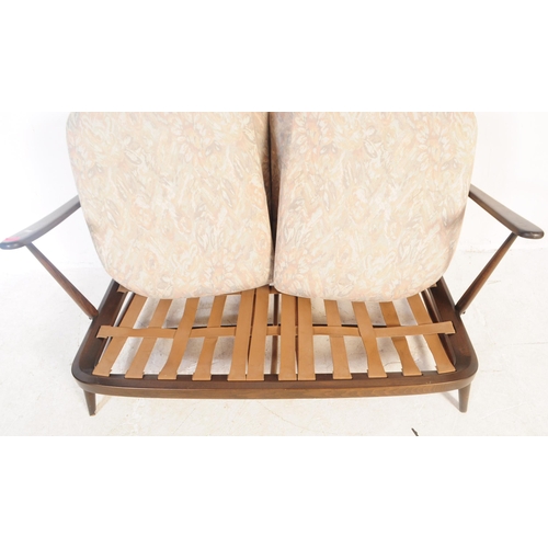 691 - Ercol - Windsor - A mid 20th century beech and elm Ercol sofa. The sofa having shaped top rail over ... 