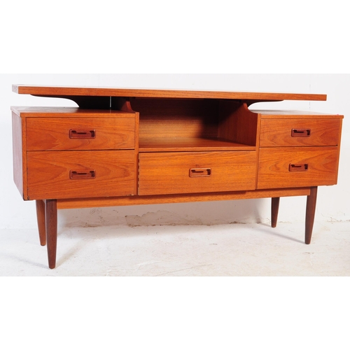 692 - A mid 20th century circa 1960s teak writing table desk. The dressing table with  floating top with c... 
