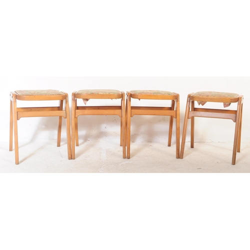695 - British Modern Design - A set of four retro mid century teak stacking stool, each upholstered with a... 