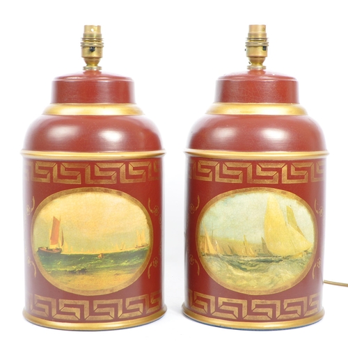 701 - A pair of toleware style ceramic barrel lamps - lights. Each in red and gilt with faux tops set with... 