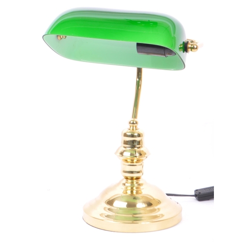 709 - A vintage 20th Century bankers office table lamp light. Having a green glass swinging shade, with br... 